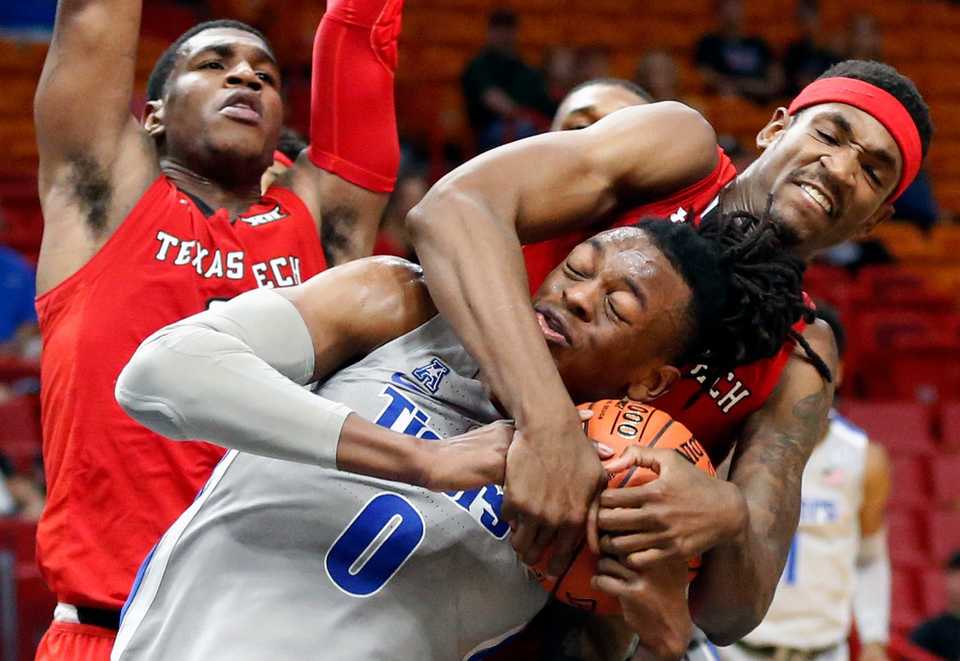 <strong>Texas Tech forward Tariq Owens (11) grabs hold of Memphis forward Kyvon Davenport (0) during the second half of an NCAA game at the Air Force Reserve Hoophall Miami Invitational in Miami, Saturday, Dec. 1, 2018. Texas Tech defeated Memphis 78-67.</strong> (AP Photo/Joel Auerbach)