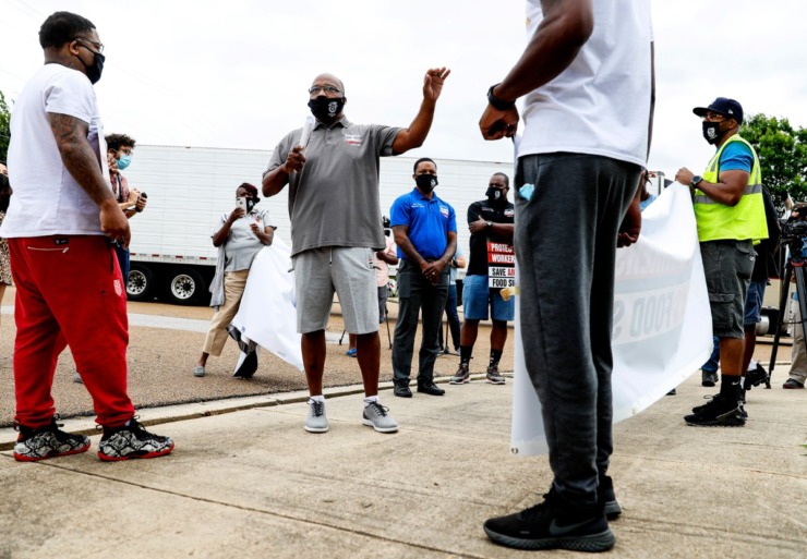 <strong>Teamsters Local 667 president James Jones (middle) speaks to Kroger employees during a rally on Wednesday, June 10, outside the Kroger Delta Division Distribution Center on Bledsoe Road.</strong> (Mark Weber/Daily Memphian)
