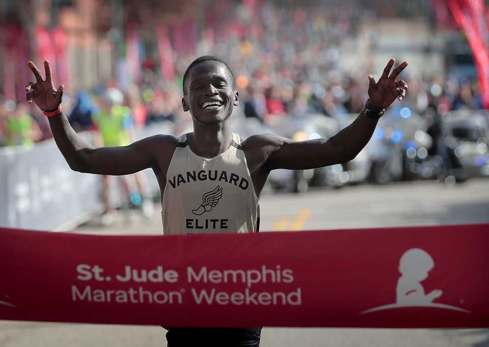 <strong>Garang Madut from Lebanon, TN crosses the finish line with a time of 2:29:04 to win the 17th annual St. Jude Memphis Marathon on Saturday Dec. 1, 2018. Despite two rain delays, over 26,000 runners participated in the charity event raising over $11 million for young cancer patients.</strong> (Jim Weber/Daily Memphian)