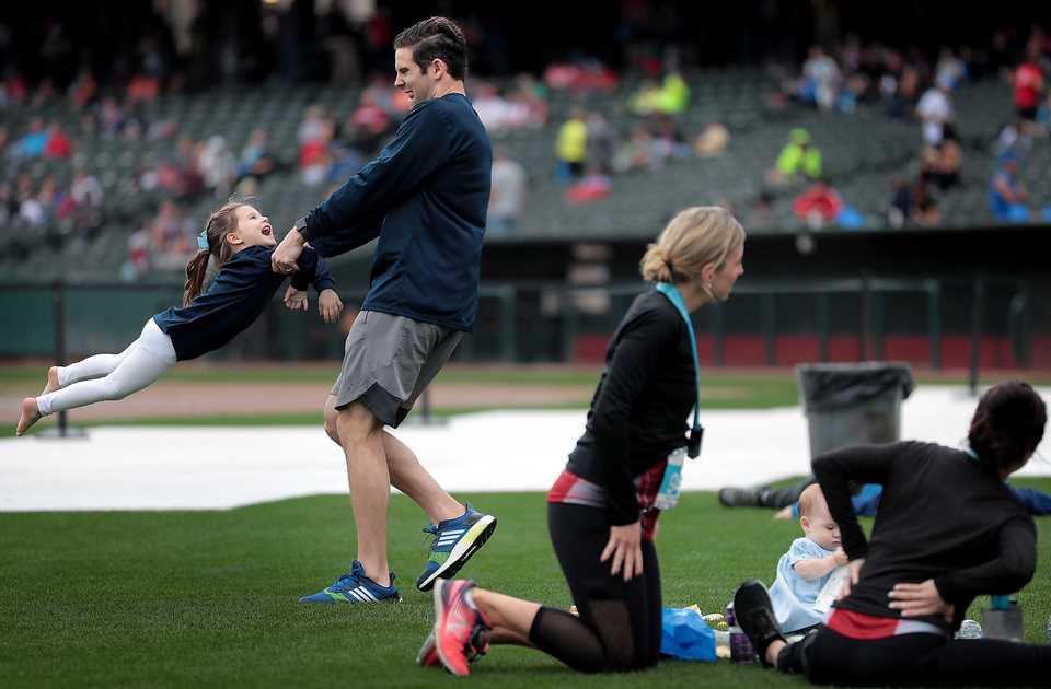 <strong>Austin Kinchen swings his daughter Cecilia, 4, on the field at Autozone Park after his wife finished running the 17th annual St. Jude Memphis Marathon on Saturday Dec. 1, 2018. Despite two rain delays, over 26,000 runners participated in the charity event raising over $11 million for young cancer patients.</strong> (Jim Weber/Daily Memphian)