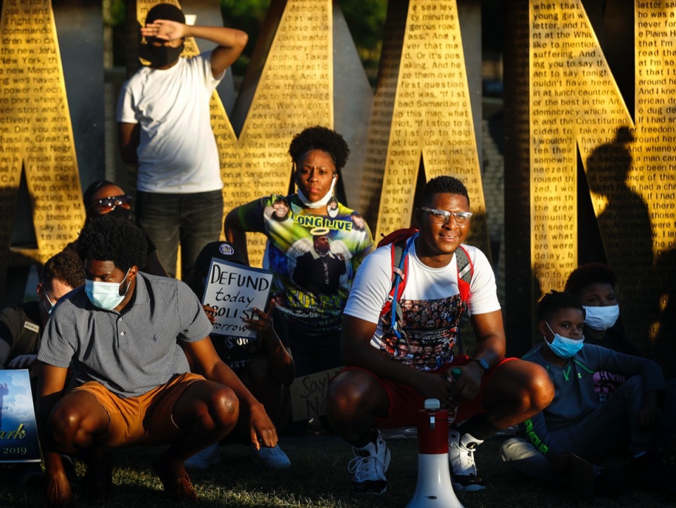 <strong>Activist DeVante Hill (right) leads protesters gathered at I Am A Man Plaza on Thursday, June 11, 2020.</strong>&nbsp;<strong>One protester holds a sign reading "Defund today, abolish tomorrow."</strong> (Mark Weber/Daily Memphian)