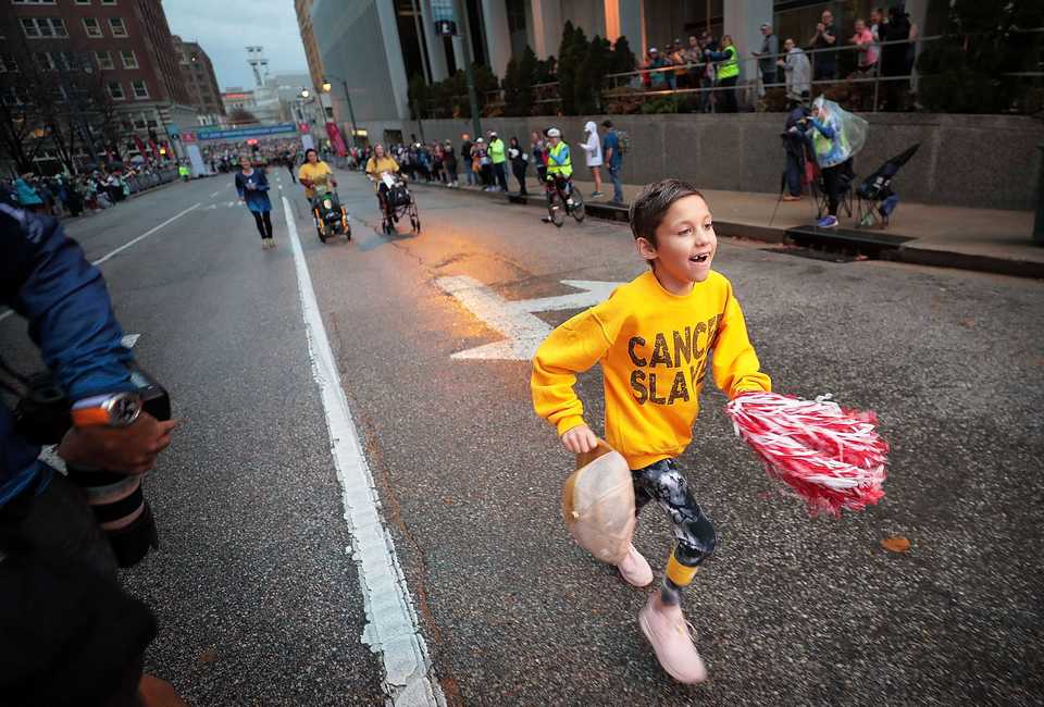 <strong>St Jude patient Kinlee Johnson, 8, starts off the 5K and 10K races with a 100 yard sprint during St. Jude Memphis Marathon activities on Saturday Dec. 1, 2018. Despite two rain delays, over 26,000 runners participated in the charity event raising over $11 million for young cancer patients.</strong> (Jim Weber/Daily Memphian)