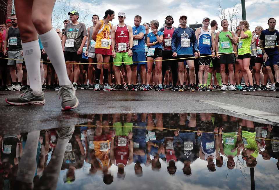 <strong>Runners line up in front of the FedExForum for at the start of the 17th annual St. Jude Memphis Marathon on Saturday Dec. 1, 2018. Despite two rain delays, over 26,000 runners participated in the charity event raising over $11 million for young cancer patients.</strong> (Jim Weber/Daily Memphian)