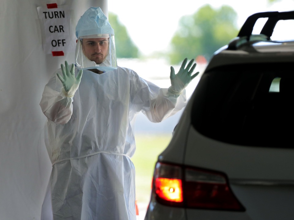 <strong>A doctor waves a possible COVID-19 patient in for testing at UTHSC&rsquo;s Tiger Lane testing site April 10, 2020. The Shelby County Health Department confirmed 256 new cases Monday, surpassing the previous single-day increase.</strong> (Patrick Lantrip/Daily Memphian)