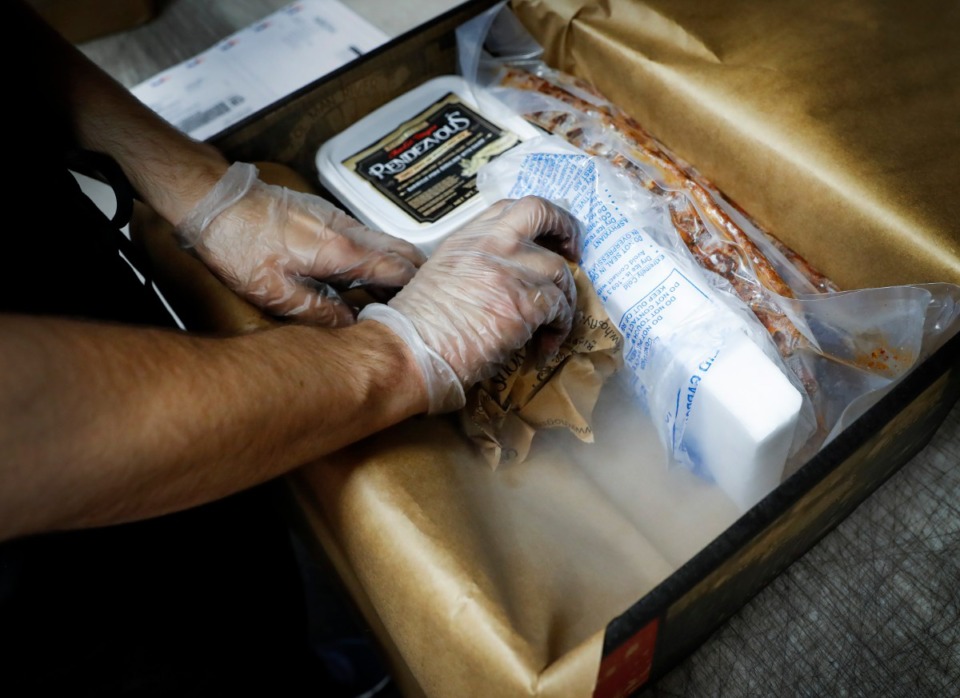 <strong>The Rendezvous uses Memphis-based nexAir dry ice to pack its barbecue for shipping on Monday, June 15. Dry ice sales have risen due to the COVID-19 pandemic and the increased shipping of foods.</strong> (Mark Weber/Daily Memphian)