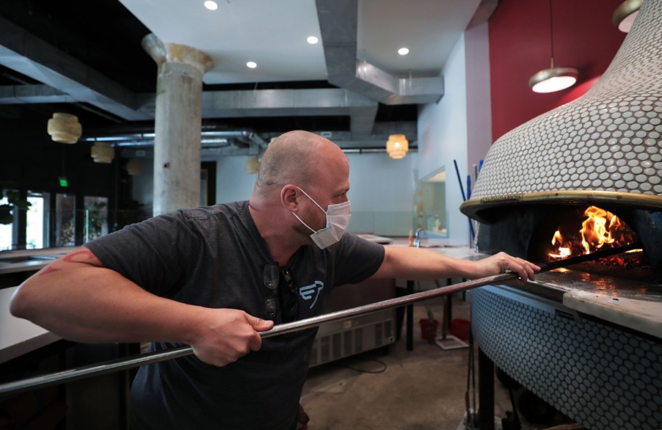 <strong>Brian Bazar tends to the fire at Pizzeria Trasimeno in Crosstown Concourse May 29, 2020. Dr. Jeff Warren, a member of the Memphis City Council, says customers are more confident of their safety when businesses follow proper mask guidelines.</strong>&nbsp;(Patrick Lantrip/Daily Memphian)