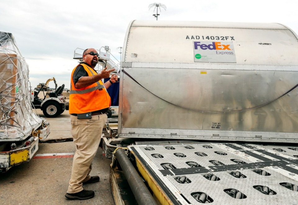 <strong>Nathan Lloyd, a manager for FedEx, directs cargo to be loaded onto a FedEx freight jet inside the company's world hub in this file photo. Cargo volume spiked at Memphis International Airport in May largely because of increased e-commerce business at FedEx.</strong> (Daily Memphian file)