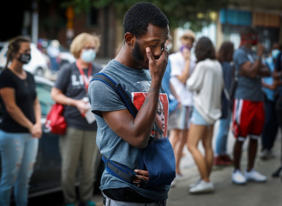 <strong>Kameron Miller wipes away tears as he looks at portraits of people killed by the police around the country during a Defund the Police Block Party on Wednesday, June 10, 2020, on South Main. Miller was arrested by Memphis Police on May 31 while protesting the death of George Floyd at the hands of Minneapolis police.</strong> (Mark Weber/Daily Memphian)