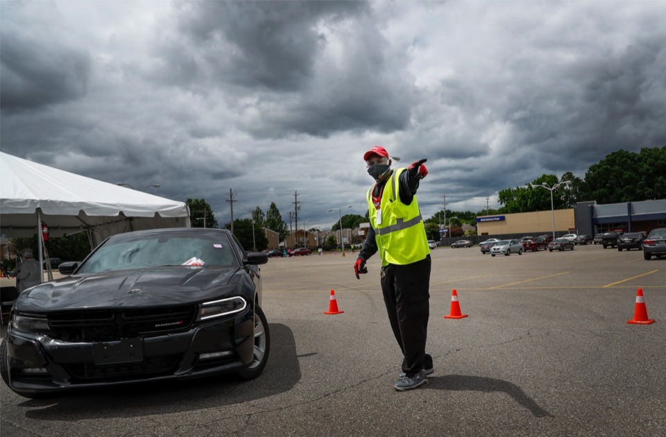 <strong>Christ Community Health Center staffer Jessie Tate directs traffic as hundreds of Memphians line up for COVID-19 testing in Hickory Hill on Tuesday, May 19, 2020.</strong> (Mark Weber/Daily Memphian)