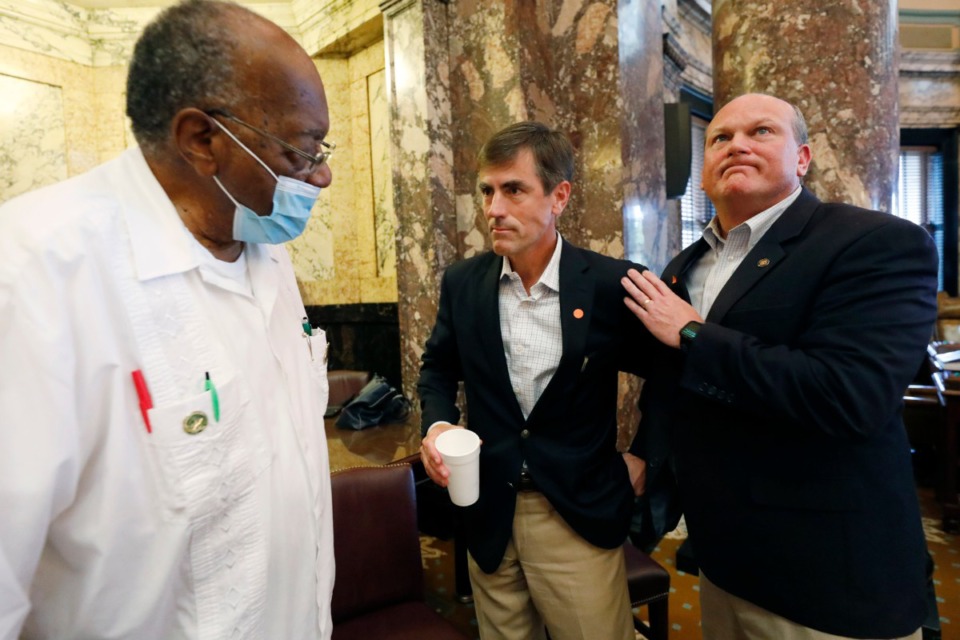 <strong>Republican Sen. Briggs Hopson (center) of Vicksburg is congratulated by Senators David Jordan (D-Greenwood, left), and Brice Wiggins (R-Pascagoula, for successfully navigating a resolution to suspend the rules and vote to change the state flag Saturday, June 27, 2020, at the Capitol in Jackson, Miss. The resolution passed and now the House and Senate are expected to pass a bill that removes the current flag and establishes a path forward to getting a new one.</strong> (Rogelio V. Solis/AP)