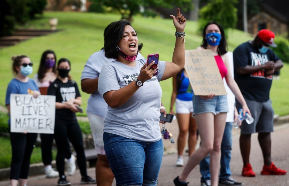 <strong>Memphis activist Theryn C. Bond (middle) leads protesters in a chant outside the home of Lloyd Crawford on Monday, June 29, 2020 in Germantown. The group was protesting Crawford, who confronted a demonstrator carrying a "Black Lives Matter" sign on Saturday.</strong> (Mark Weber/Daily Memphian)