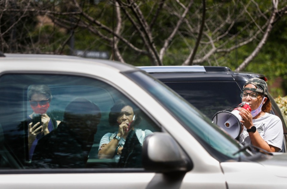 <strong>Memphis Activist LJ Abraham (right) uses a bullhorn confront a man in his truck after the crowd indicated he nearly hit protesters while they demonstrated in Germantown.</strong> (Mark Weber/Daily Memphian)