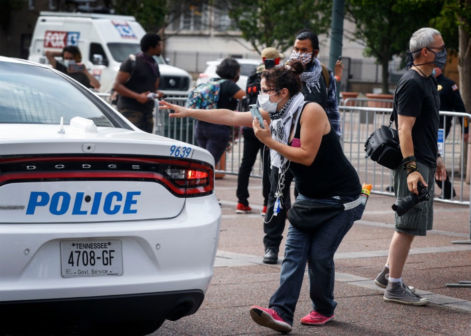 <strong>Memphis activist Seema Rasoul (middle) waves to a protester who is inside a police car after being arrested outside City Hall on Wednesday, July 1, 2020.</strong> (Mark Weber/Daily Memphian)