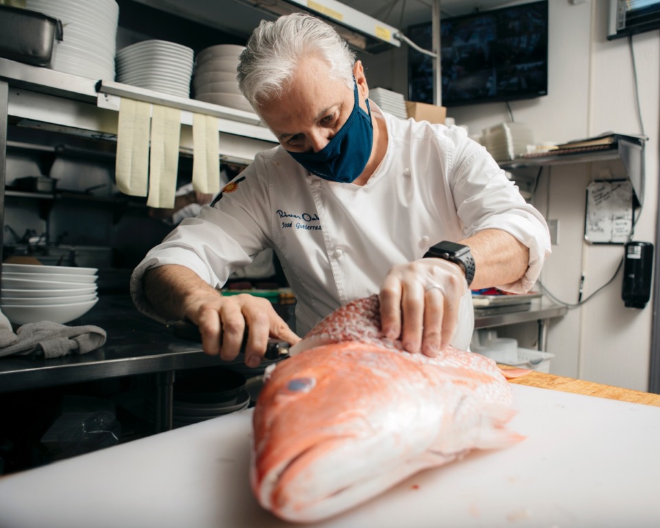 <strong>Jos&eacute; Gutierrez, master chef and owner of River Oaks restaurant, fillets a large red snapper as he prepares to put it on the grill. Gutierrez&rsquo;s restaurant is hosting dine-in seating and curbside pick up during the pandemic.</strong> (Houston Cofield/Special to The Daily Memphian)