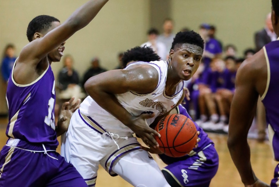 <strong>CBHS guard Chandler Jackson (middle) drives the lane against the Christian Brothers College defense during action Thursday, Jan. 2 2020 at Hoopsfest.</strong> (Mark Weber/Daily Memphian file)