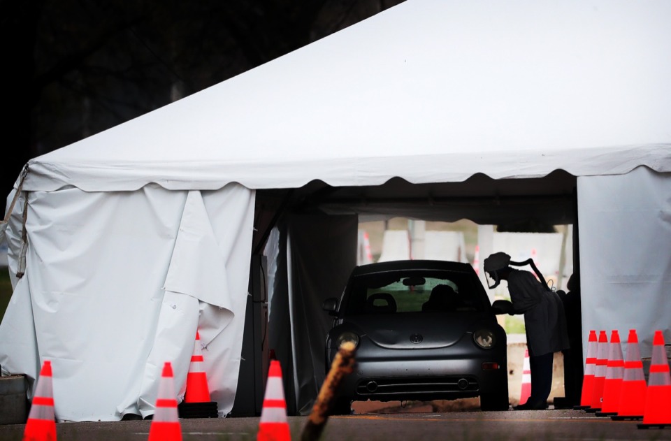 <strong>Staff and students from the University of Tennessee Health Science Center conduct drive-thru COVID-19 testing at the Memphis Fairgrounds on March 25, 2020</strong>. (Jim Weber/Daily Memphian file)