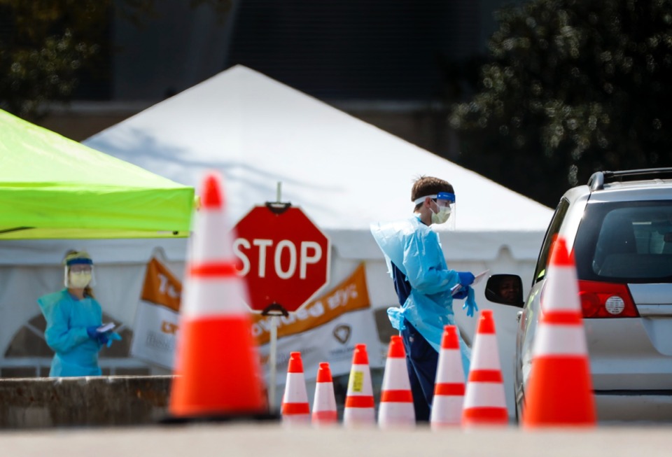 <strong>Staff and students from the University of Tennessee Health Science Center continue drive-thru testing for COVID-19 at the Memphis Fairgrounds in April.</strong> (Mark Weber/ The Daily Memphian file)