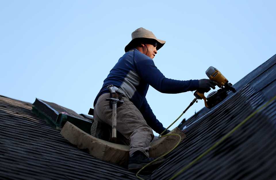 <strong>Luis Nino with Gomez Roofing works on a home in the multi-phase Shea Crossing subdivision in Collierville.&nbsp;</strong>(Houston Cofield/Daily Memphian)