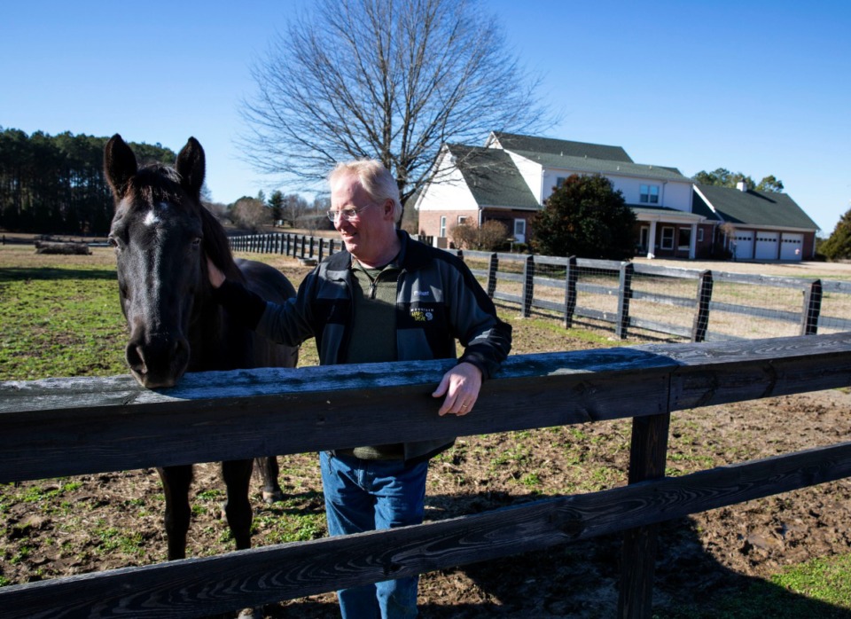 <strong>Robert Slaughter enjoys a warm winter day with one of his horses at his home on Quinn Road in southeast Shelby County on Jan. 5, 2020. Slaughter and his neighbors were concerned about the Quinn Ridge development, which was being considered at the time. They worried that the development of more than 500 houses (which has now been cut to 450, maximum) on land adjacent to Slaughter's property would ruin the rural, farm-like feel of their homes.</strong><span>&nbsp;(Mike Kerr/Daily Memphian file)</span>