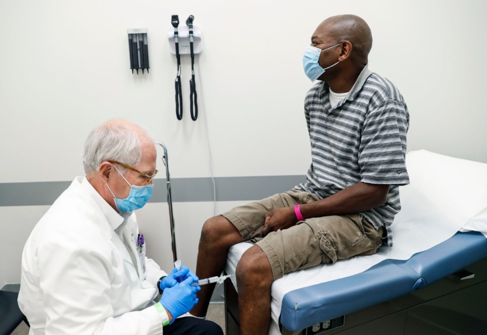 <strong>Church Health&rsquo;s Dr. Scott Morris (left) administers a cortisone shot to the knee of patient Glen Edwards (right) on Thursday, July 16, 2020, inside Crosstown Concourse.</strong> (Mark Weber/Daily Memphian)