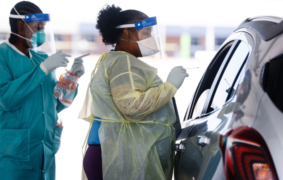 <strong>Christ Community Health Center medical staff collect nasal swabs as hundreds of Memphians line up for COVID-19 testing at its site in Hickory Hill on Tuesday, July 14, 2020.</strong> (Mark Weber/Daily Memphian)