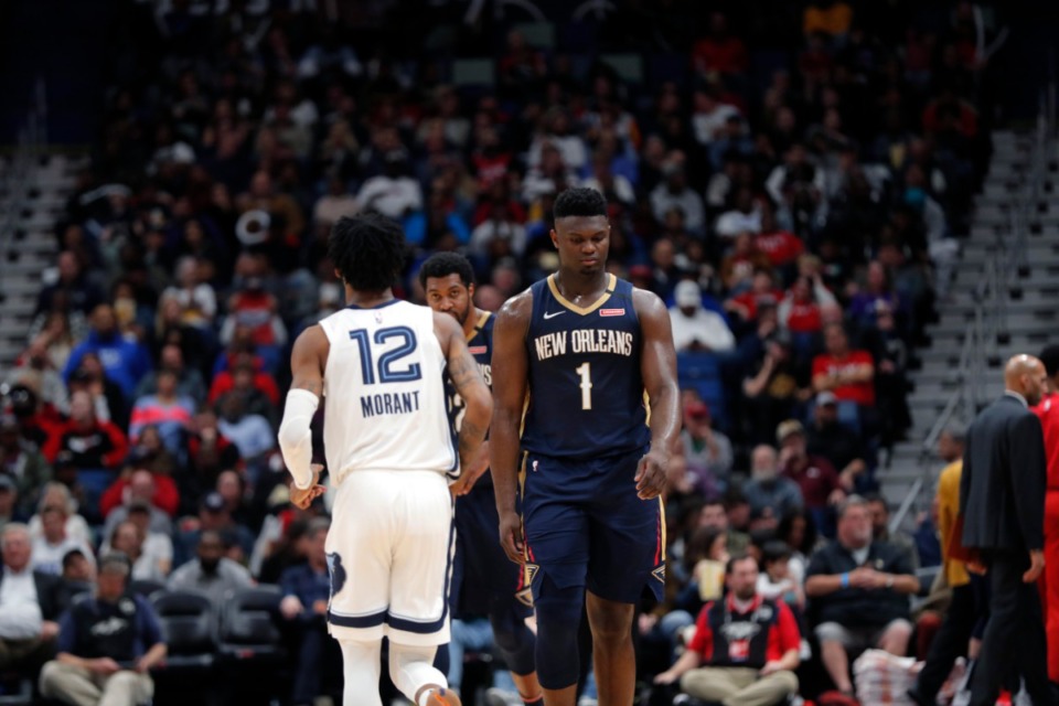 <strong>New Orleans Pelicans forward Zion Williamson (1) walks past Memphis Grizzlies guard Ja Morant (12) in the second half of an NBA basketball game in New Orleans, Friday, Jan. 31, 2020. The Pelicans won 139-111.</strong> (AP Photo/Gerald Herbert)