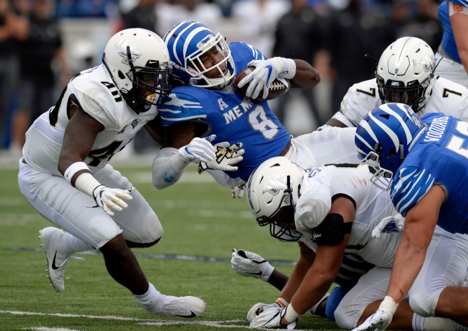 <strong>In this file photo, Memphis running back Darrell Henderson (8) runs for a first down as he is hit by Central Florida linebacker Eriq Gilyard (40) during the first half of an NCAA college football game Oct. 13, 2018, in Memphis, Tenn.</strong> (AP Photo/Mark Zaleski)