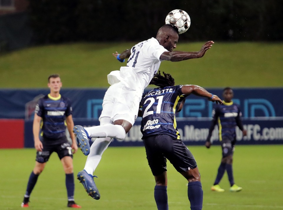 <strong>Charlotte Independence midfielder Brunallergene Etou (21) climbs over Memphis 901 FC midfielder Duane Muckette (21) for a header during a game July 25, 2020.</strong> (Patrick Lantrip/Daily Memphian)