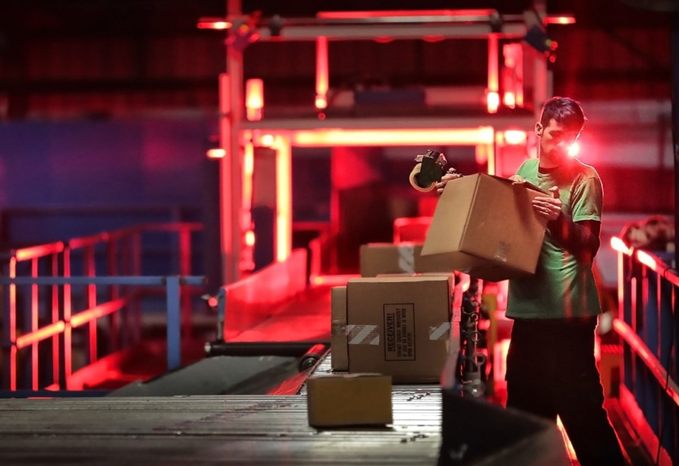 <strong>A worker at the FedEx Ground Hub in Olive Branch re-tapes a package before it moves through a scanning tunnel at the FedEx Ground Hub.</strong> (Jim Weber/Daily Memphian file)