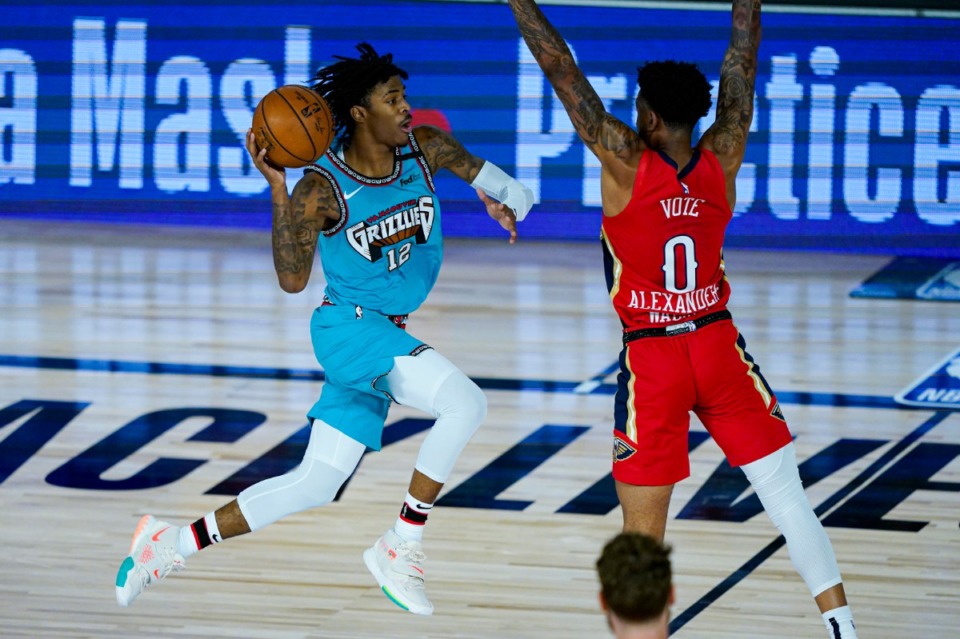 <strong>Memphis Grizzlies' Ja Morant misses a shot at the buzzer over New Orleans Pelicans' Nickeil Alexander-Walker during the first half of an NBA basketball game on Monday, Aug. 3, in Lake Buena Vista, Fla.</strong> (Ashley Landis/Associated Press)