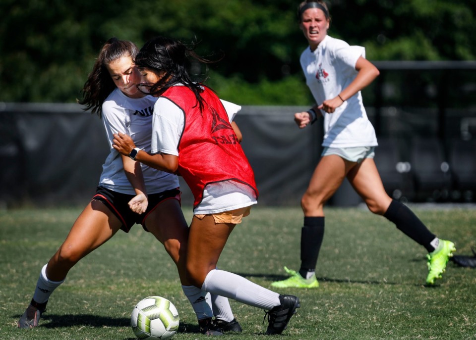 <strong>Houston High School girls soccer player Kate O&rsquo;Connor (left) battles Lauren Fang (right) during practice on Wednesday, Aug. 5.</strong>&nbsp;<strong>The Germantown school district is one of four districts in the area that has begun full-scale preparations for football season in light of Gov. Bill Lee&rsquo;s decision Friday to sign Executive Order No. 55.&nbsp;</strong>(Mark Weber/Daily Memphian)