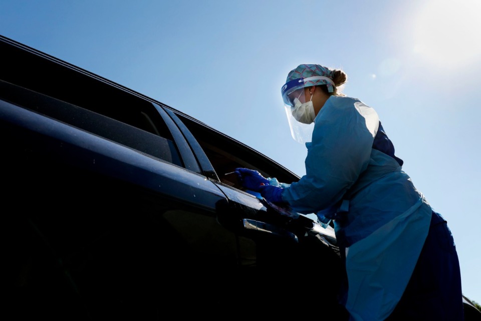 <strong>Registered nurse Holly Cote administers COVID-19 testing swabs during a drive-thru testing site Thursday, June 18, 2020 at Baptist Memorial Hospital-Memphis.</strong> (Mark Weber/Daily Memphian)