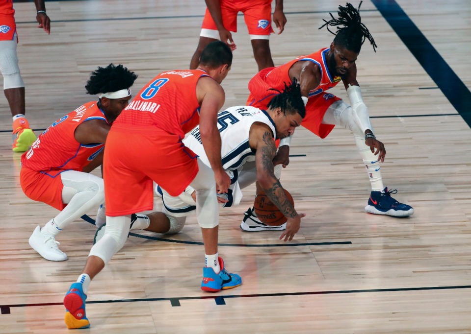 <strong>Memphis Grizzlies forward Brandon Clarke (15) plays for the ball against Oklahoma City Thunder center Nerlens Noel (9), guard Shai Gilgeous-Alexander (2) and forward Danilo Gallinari (8) during their game Friday, Aug. 7, in Lake Buena Vista, Fla.</strong> (Kim Klement/Associated Press)