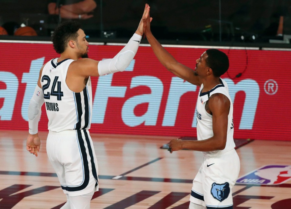 <strong>Memphis Grizzlies guards Dillon Brooks (24) and De'Anthony Melton (0) celebrate after a play against the Oklahoma City Thunder during the second half of an NBA basketball game Friday, Aug. 7, 2020, in Lake Buena Vista, Fla.</strong> (Kim Klement/Pool Photo via AP)