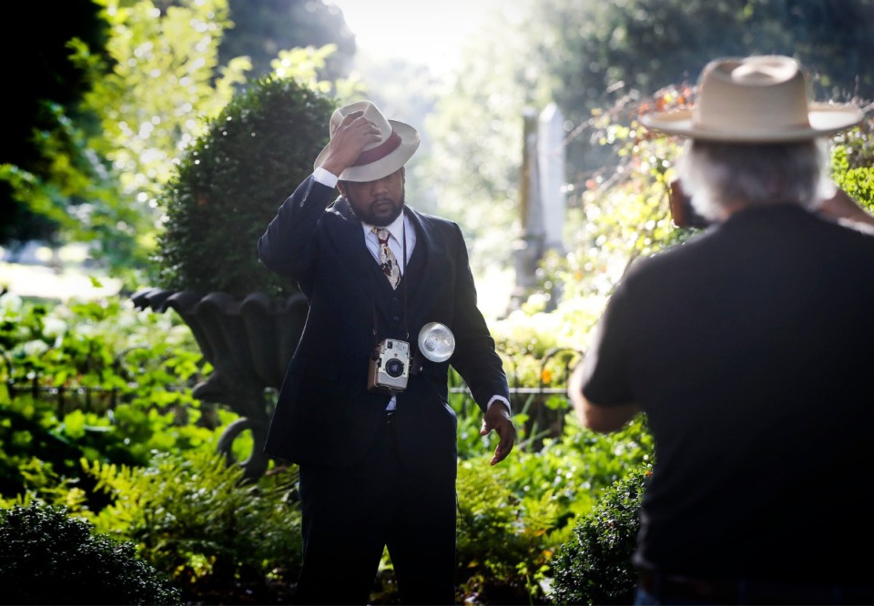 <strong>Actor Terry Rogers, (middle) adjusts his hat while portraying civil rights photographer Ernest Withers during filming of Elmwood Cemetery&rsquo;s annual fall &ldquo;Soul of the City&rdquo; tour on Friday, July 31, 2020. The cemetery&rsquo;s annual fundraiser can be experienced virtually this year due to the pandemic.</strong> (Mark Weber/Daily Memphian)