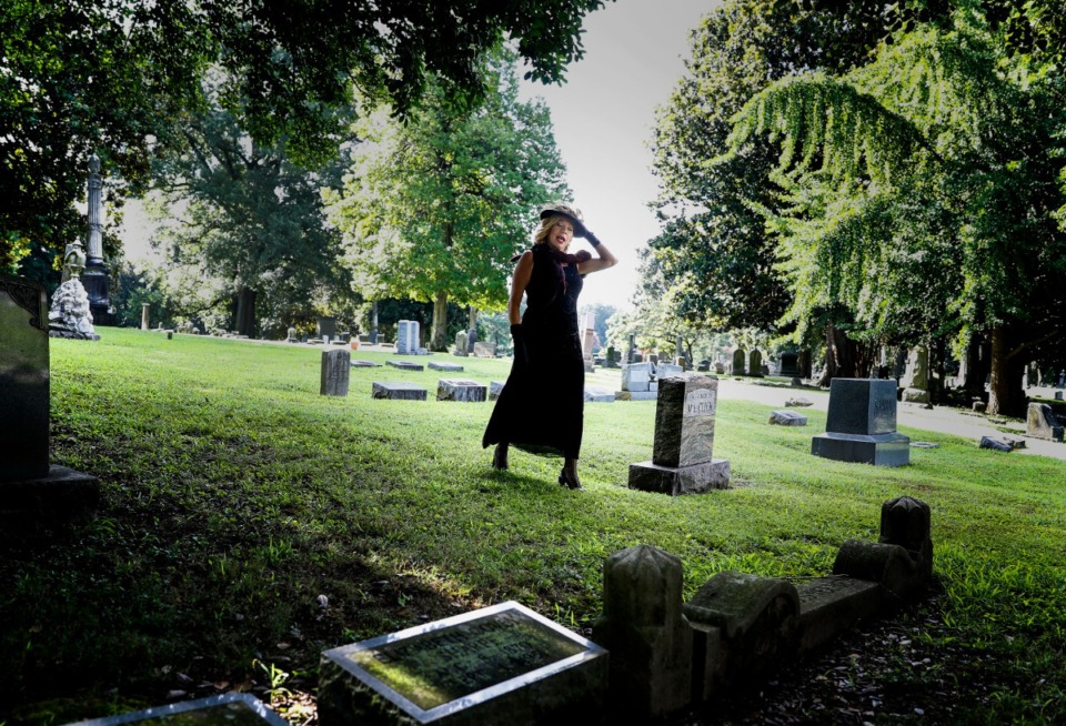 <strong>Actress Susan &ldquo;Cookie&rdquo; Swain who is portraying Geneva Barnes Ramsey Williams, who was the first wife of notorious gangster Machine Gun Kelly, walks through tombstones during filming of Elmwood Cemetery&rsquo;s annual fall "Soul of the City" tour on Friday, July 31, 2020. The cemetery&rsquo;s annual fundraiser can be experienced virtually this year due to the pandemic.</strong> (Mark Weber/Daily Memphian)