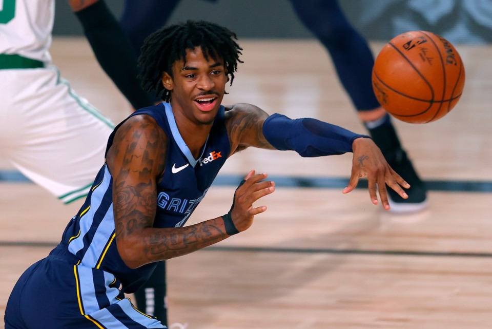 <strong>Memphis Grizzlies&rsquo; Ja Morant passes the ball during the game against the Boston Celtics Tuesday, Aug. 11,&nbsp; in Lake Buena Vista, Fla.</strong>&nbsp;<strong>Morant played a career-high 42 minutes and scored 26 points, but it wasn&rsquo;t enough for a win; Memphis dropped its second straight game, 122-107.&nbsp;</strong>(Mike Ehrmann/Associated Press)