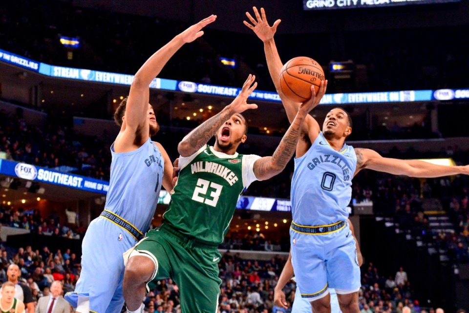 <strong>Milwaukee Bucks guard Sterling Brown (23) shoots between Memphis Grizzlies forward Kyle Anderson, left, and guard De'Anthony Melton (0) last December.</strong> (AP file Photo/Brandon Dill)