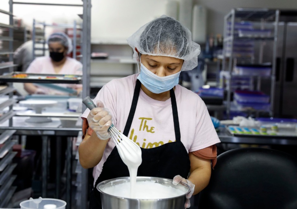 <strong>The Whimsy Cookie Company team member Daisy Lopez mixes icing on Thursday, Aug. 6, 2020.</strong> (Mark Weber/Daily Memphian)