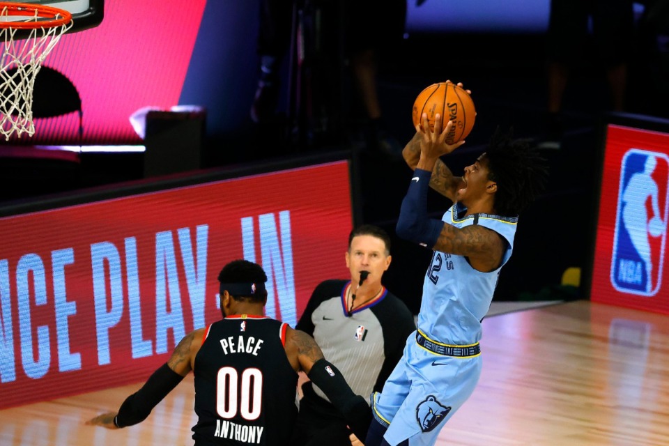 <strong>Memphis Grizzlies' Ja Morant, right, goes up for a shot against the Portland Trail Blazers during the first half of an NBA basketball game Saturday, Aug. 15, 2020, in Lake Buena Vista, Fla.</strong> (Kevin C. Cox/AP)