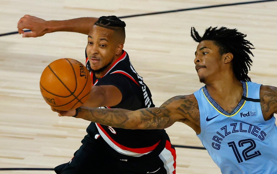 <strong>Memphis Grizzlies' Ja Morant (12) and Portland Trail Blazers&rsquo; CJ McCollum go after a rebound during the second half of an NBA basketball game Saturday, Aug. 15, 2020, in Lake Buena Vista, Fla. </strong>(Kevin C. Cox/AP)