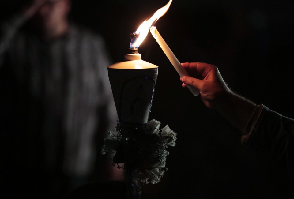 <strong>Though some years have brought over 100,000 visitors from all over the world, this year's candlelight vigil at Graceland featured a much smaller and spread out crowd.</strong> (Patrick Lantrip/Daily Memphian)
