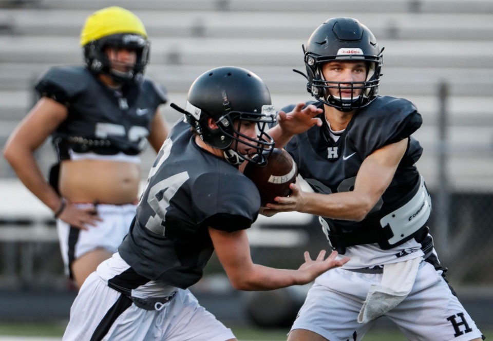 <strong>Houston quarterback Gray Nischwitz (right) makes a handoff during football practice on Thursday, Aug. 13, 2020.</strong> (Mark Weber/Daily Memphian)