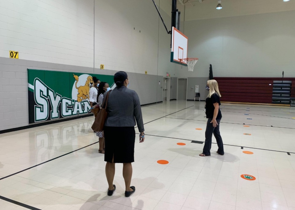 <strong>Sycamore Elementary Principal Julie Reagan (right) shows Shelby County Health Department employees the school&rsquo;s plans to social distance during physical education class.</strong> (Abigail Warren/Daily Memphian)