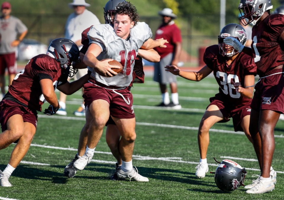 <strong>Collierville High School tight end Brayden Hendricks (middle) loses his helmet during football practice on Wednesday, Aug. 5.</strong> <strong>The Dragons were set to kick off their 2020 season on Friday against visiting Briarcrest with no media in attendance.</strong> (Mark Weber/Daily Memphian)