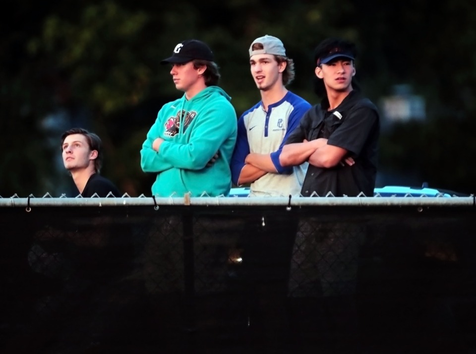 <strong>Due to the limited seating protocols in place at Houston High School, a group of students peer over the fence to watch the football game against CBHS Aug. 21, 2020.</strong> (Patrick Lantrip/Daily Memphian)