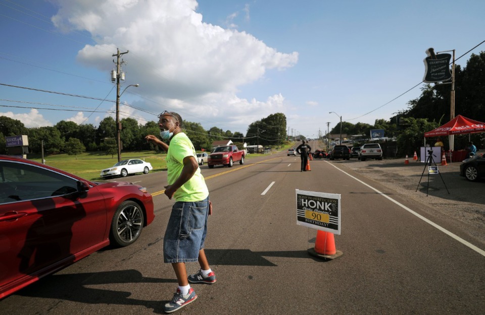 <strong>Keith King encourages passing cars to honk their horn to celebrate Dr. Charles Champion's 90th birthday Aug. 22, 2020.</strong> (Patrick Lantrip/Daily Memphian)