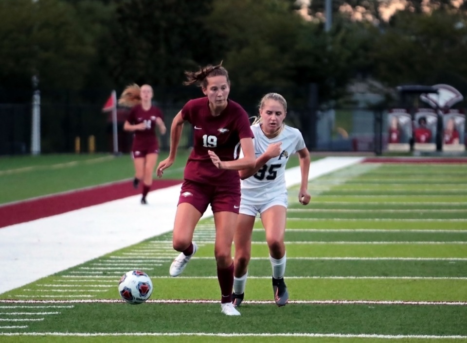 <strong>Evangelical Christian School's Delaney Stookey (19) fights for a loose ball against Arlington High School's Jessica Richardson (35) during an Aug. 25 home game.</strong> (Patrick Lantrip/Daily Memphian)