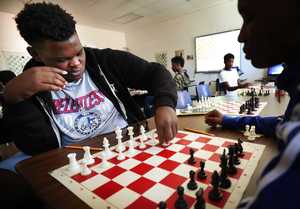 <strong>Sophomore Jalen Royal (left) ponders a move against Kylan Richardson in Kuwane Turner's chess class at Douglass High School on Aug. 27. The class helps teach students good sportsmanship as well as critical and strategic thinking</strong>. (Jim Weber/Daily Memphian)