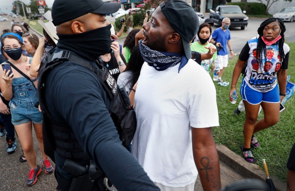 <strong>Activist Keedran Franklin (right) talks with Memphis Police as protesters are moved off of Winchester Ave., on Friday, July 17, 2020. Family members of Darrius Stewart, who was shot and killed five years ago by Memphis Police Officer Connor Schilling, held a vigil and protest in Stewart&rsquo;s honor.</strong> (Mark Weber/Daily Memphian)